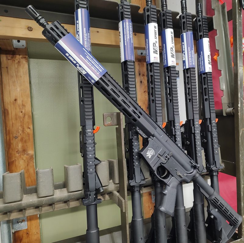 A Smith & Wesson M&P Sport 3 Rifle is displayed upright with a label attached, featured as the prize in the RAFFLE TICKET - SOTAR Secret Shopper event.