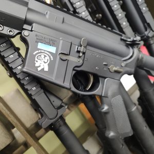 Close-up of a Smith & Wesson M&P Sport 3 rifle, featuring a visible safety selector and manufacturer markings. Other rifles are lined up in the background. RAFFLE TICKET - SOTAR Secret Shopper available for this model.