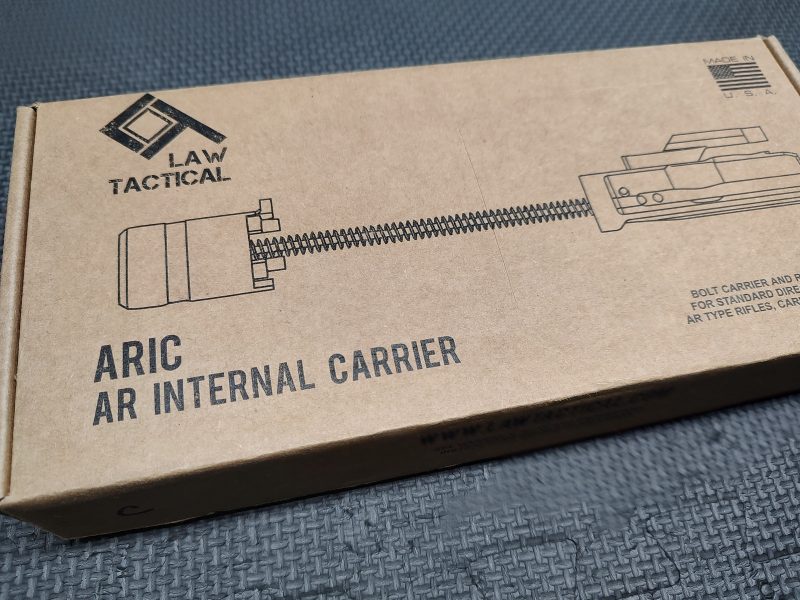 A cardboard box labeled "LAW Tactical ARIC - C Model" with a black line drawing of the product on top.