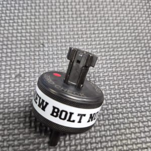 A black plastic SOTAR AR15 NEW Bolt Support Ring NOGO Gauge with a white "NEW BOLT NO" label rests on a textured gray surface.