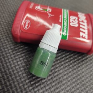 A 5ML Tube Loctite 620 of green liquid next to a red bottle.
