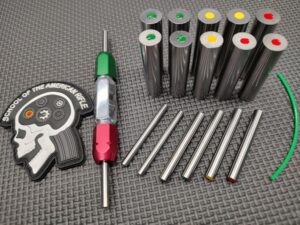 A SOTAR BCG 3 Bore & Gas System Gauge Set of metal rods and a set of colored pins.