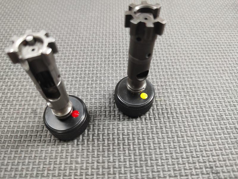 Two SOTAR AR15 Bolt Tail Gauge Sets with red and yellow markings on a textured gray surface.