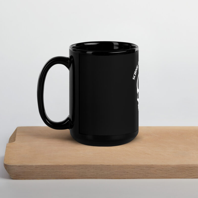 A SOTAR Black Glossy Mug with a skull and crossbones on it.