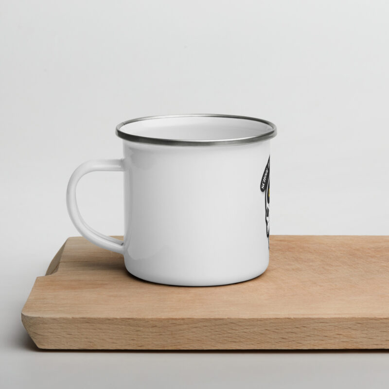 A SOTAR enamel mug sitting on a cutting board.