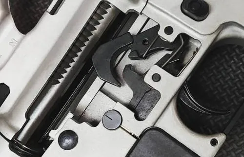 A close up of a gun with a piece of metal on it.